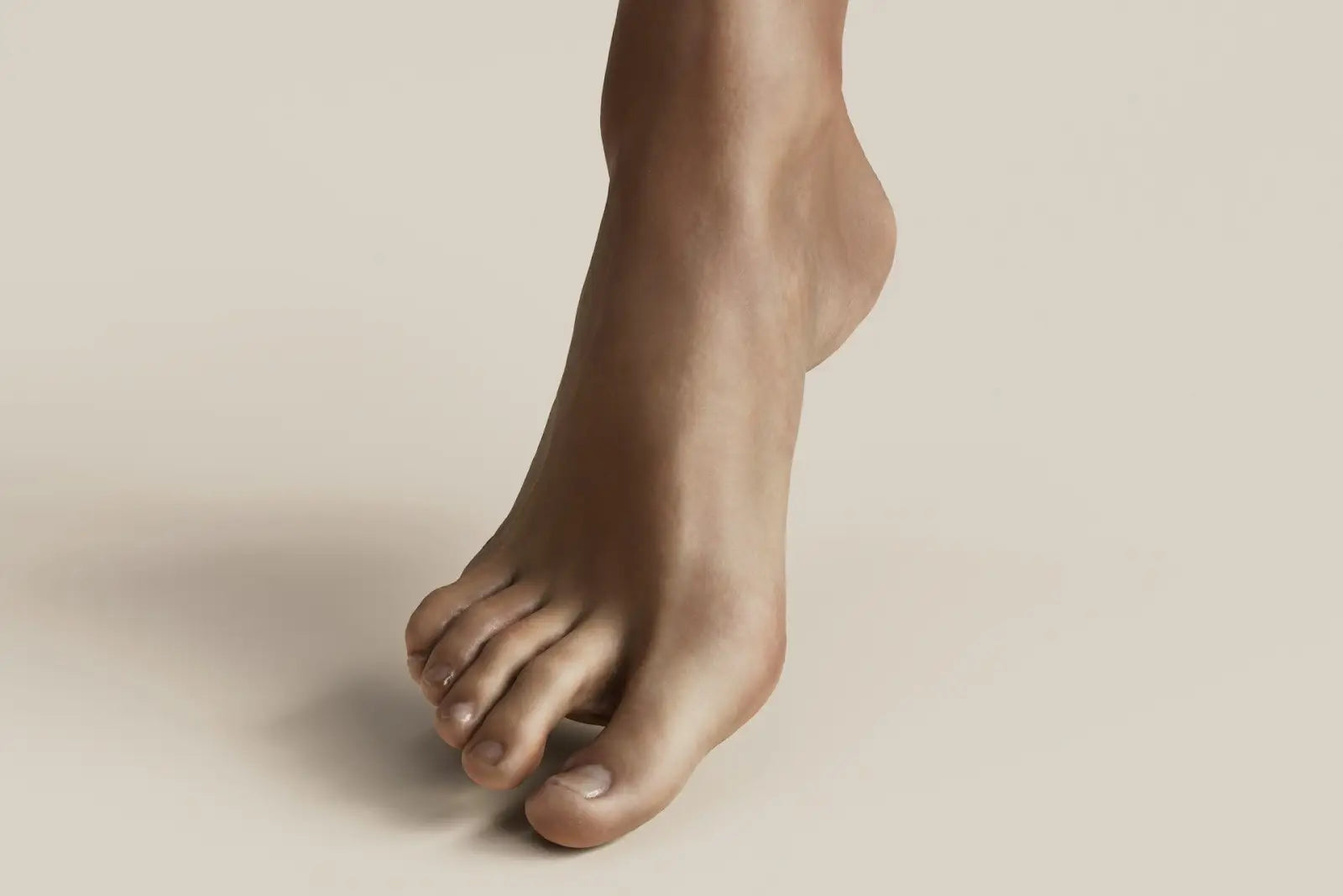 Close-up of a human foot showing big toe extension and joint alignment, illustrating the role of the hallux in balance, propulsion, and gait mechanics related to foot health and mobility.