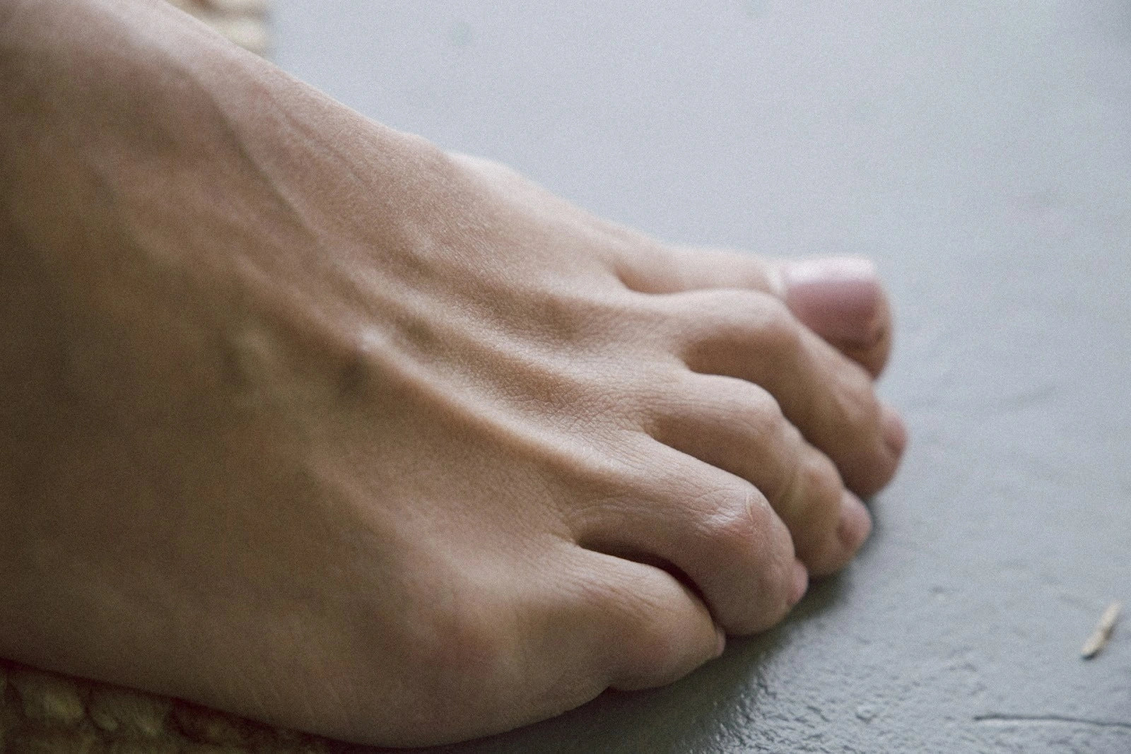Close-up of a person’s foot showing the pinkie toe and outer forefoot, highlighting the small toe’s role in lateral stability, balance, and foot mechanics.