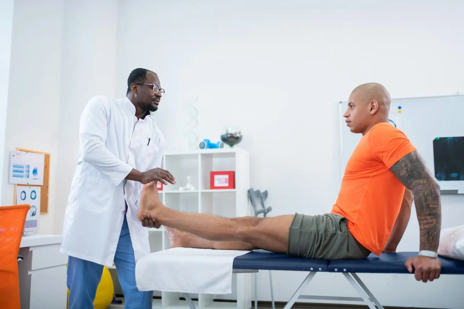 Clinician assessing a patient’s foot mobility during a physical therapy session, representing clinical strategies and instruments for big toe recovery and mobility improvement.